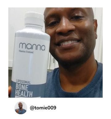 A manna customer holding up a bottle of Liposomal Bone Health 1