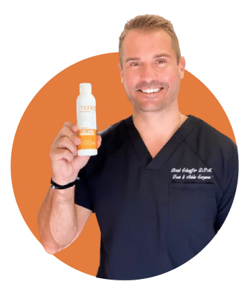 Doctor Bradley Schaeffer holding up a bottle of Liposomal Curcumin