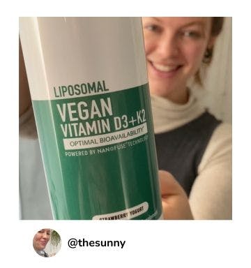 A manna customer holding up a bottle of Liposomal Vegan Vitamin D3 + K2 4