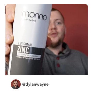 A manna customer holding up a bottle of Liposomal Zinc 2